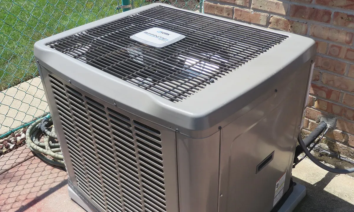 An air conditioning condenser unit outside a home